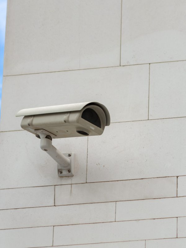 Surveillance camera built into the stone wall of the building, close up